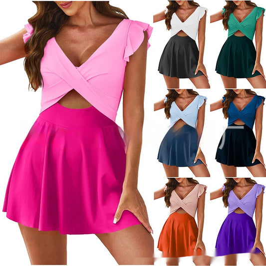 Pink dress with cut-out design on a white background, surrounded by other colorful dresses.