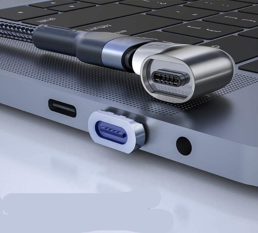 Laptop with a USB-C cable and dust plug on a light gray background