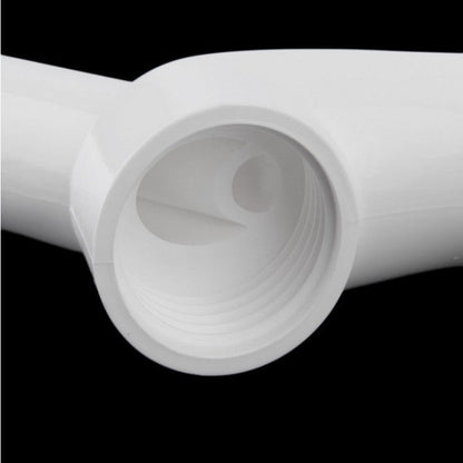 Close-up of a white plastic pipe on a black background