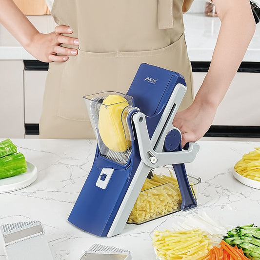 Person using a blue and gray vegetable slicer in a kitchen.