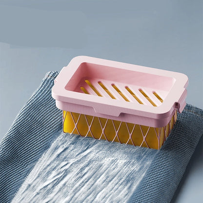 Pink and yellow soap dish on a textured surface with text 'Rich sparkling Apply evenly'.