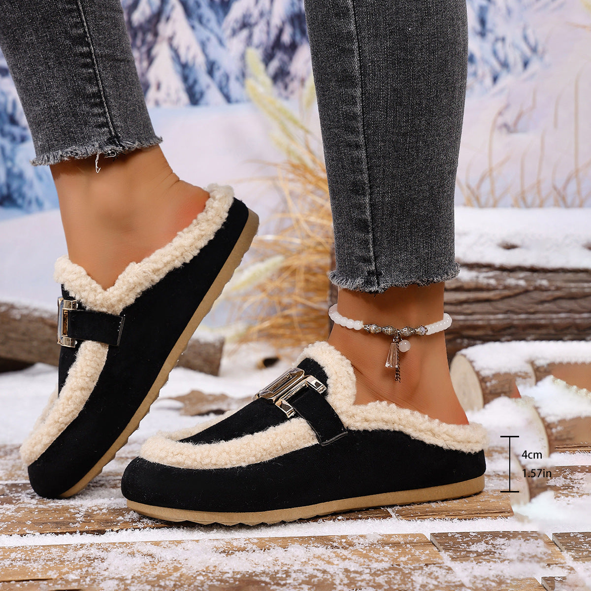 Black and beige winter shoes worn with jeans on a snowy background