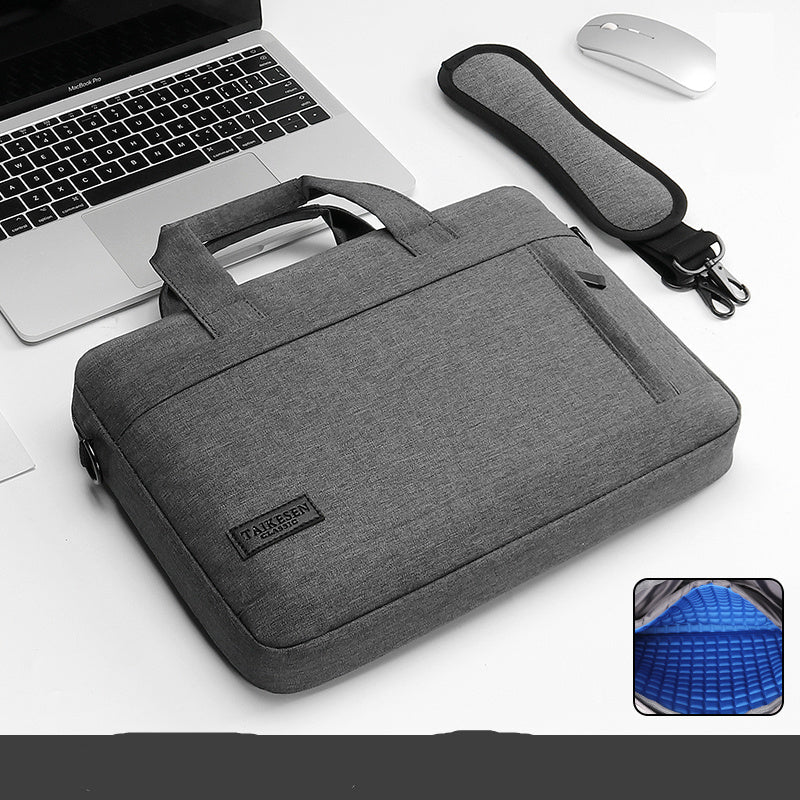 Black laptop bag with a handle and zipper closure, displayed next to a laptop and a mouse, with an inset showing the interior of the bag.