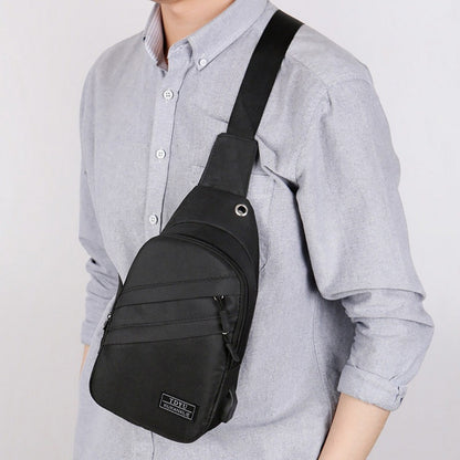 Person wearing a black sling bag over one shoulder on a plain background