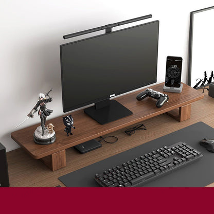 Monitor stand made of black walnut wood, with a computer monitor, keyboard, and various desk accessories on it, placed on a wooden floor against a white background.
