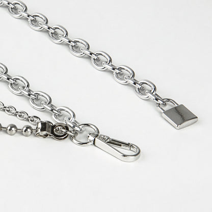 Close-up of a silver chain with clasp on a white background