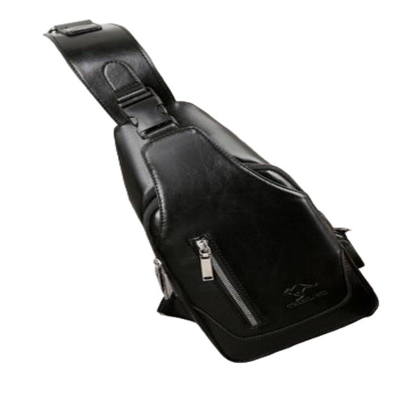 Black leather sling bag on a light gray surface with headphones nearby