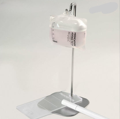 Innovative earphone case designed like a medical vial with a stand on a white background.