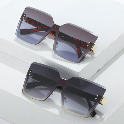 Two pairs of sunglasses with different designs on a white surface