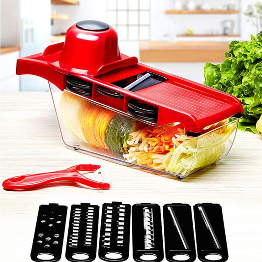 Red vegetable slicer with clear container filled with sliced vegetables on a kitchen counter.