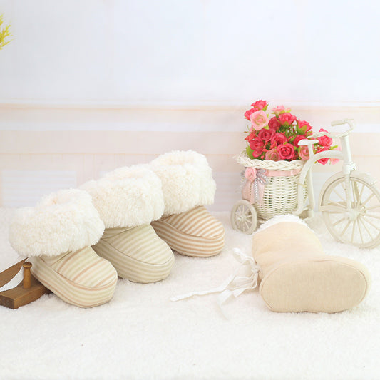 Pair of white slippers on a light background with decorative elements like a small bicycle and flowers.