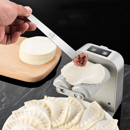 Dough press making dumpling wrappers with a hand holding a sheet of dough.
