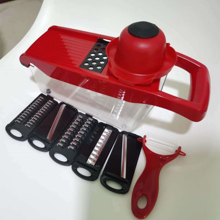Red mandoline slicer with interchangeable blades on a white background