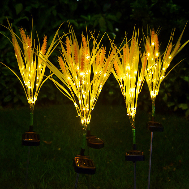 Set of solar-powered LED grass lights on a dark background
