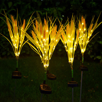 Set of solar-powered LED grass lights on a dark background
