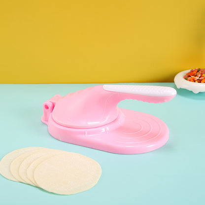 Pink tortilla press with tortillas on a colorful background