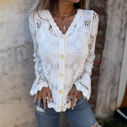 Woman wearing a white lace cardigan with a neutral background
