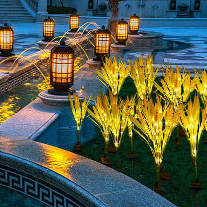 Decorative outdoor lights with water feature and palm tree-like structures.