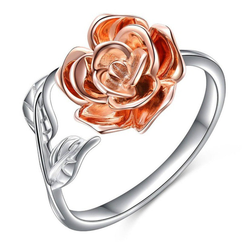 Rose gold and silver rose-shaped ring on a white background
