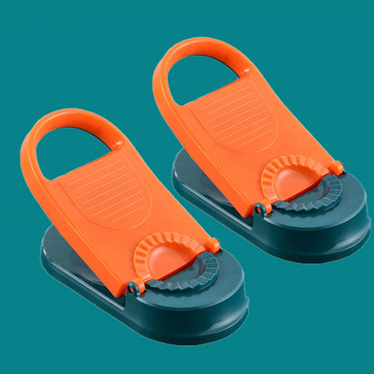 Two orange and green plastic clips on a teal background