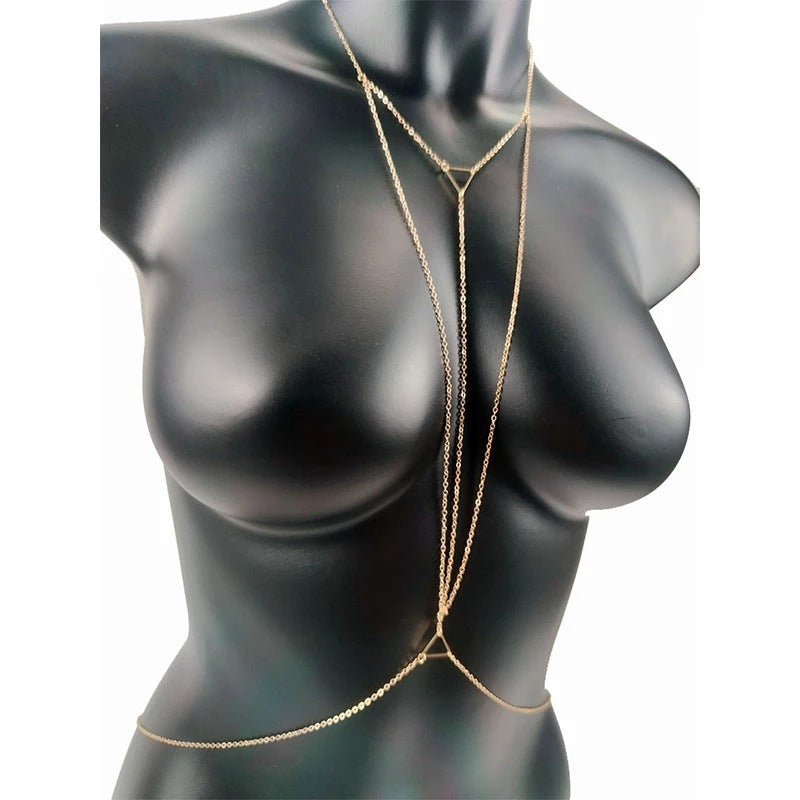 Gold chain body jewelry on a black mannequin