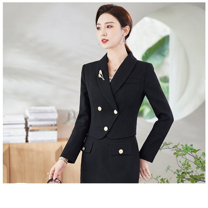 A woman in a white leisure formal suit with a blazer and a skirt, featuring long sleeves and gold buttons, standing outdoors.