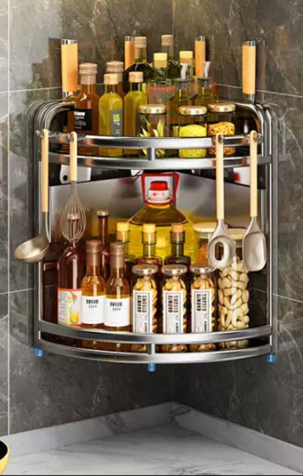 Corner kitchen storage rack with bottles and utensils against a gray tiled wall.