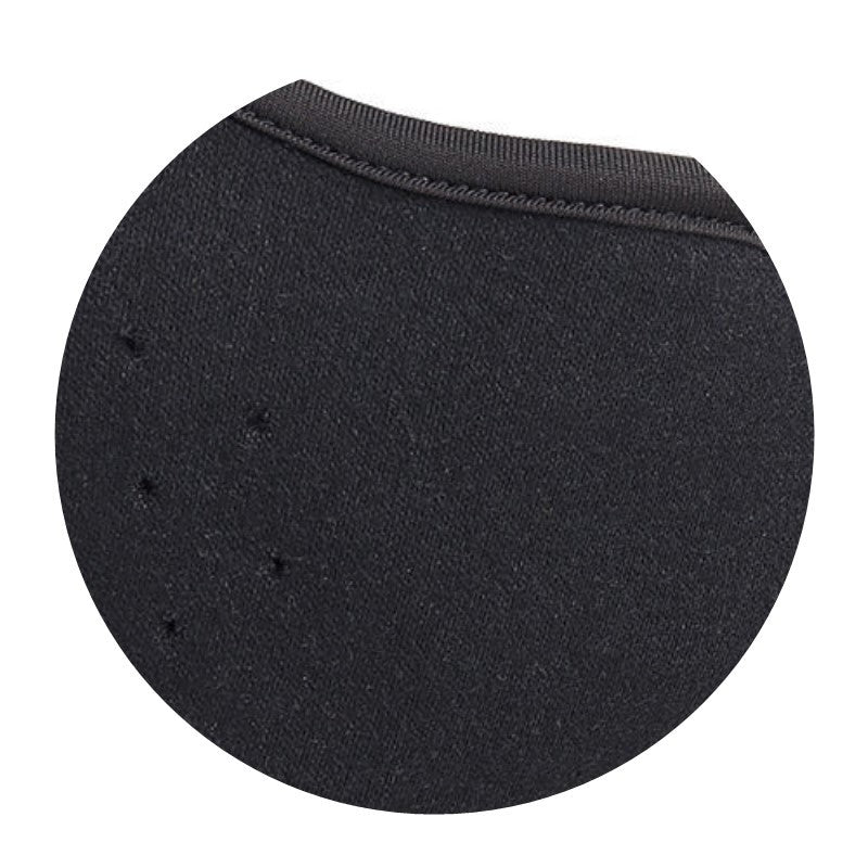 Black circular cushion with textured surface on a white background