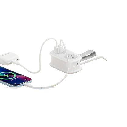 White power strip with flat plug design on a wooden surface, showing space efficiency.