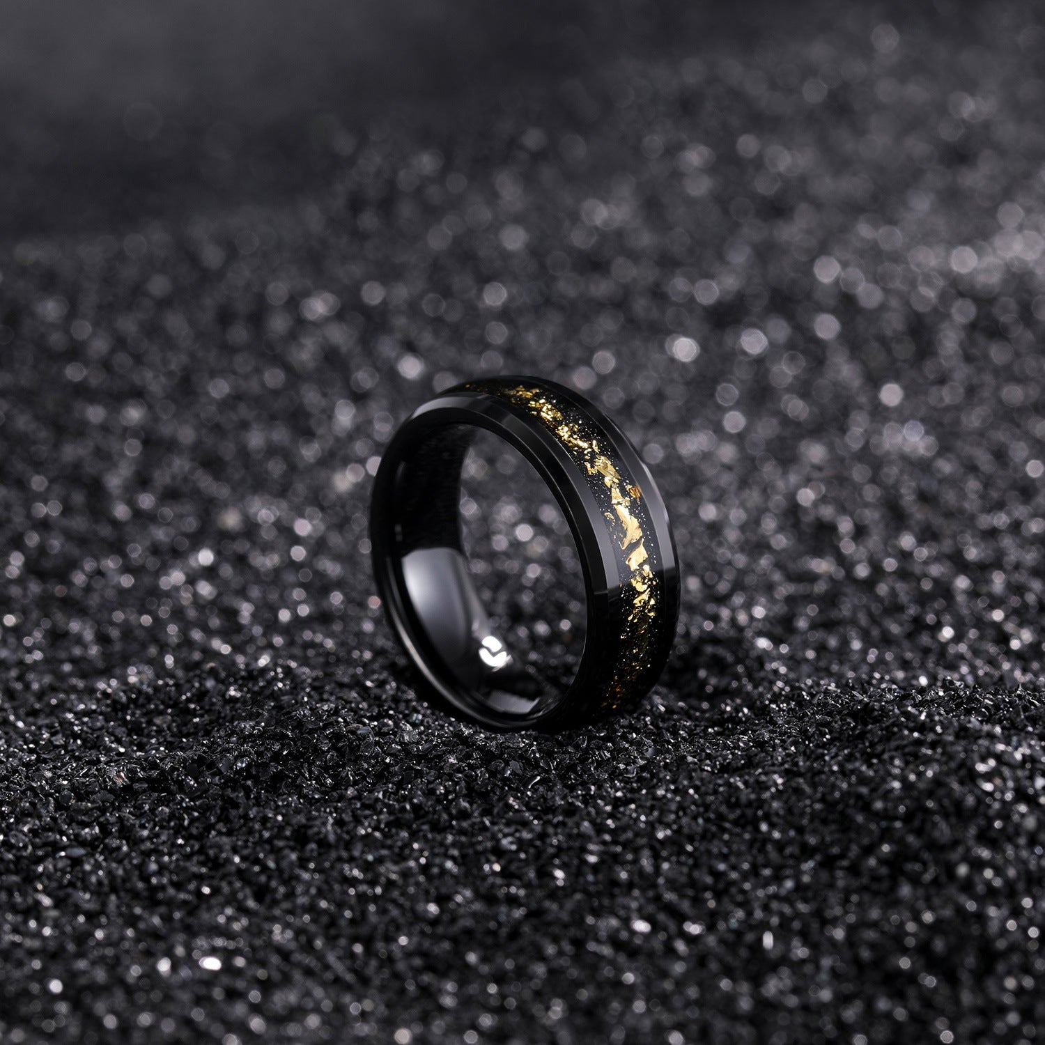 Black ring with gold accents on a black textured background