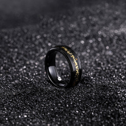 Black ring with gold accents on a black textured background