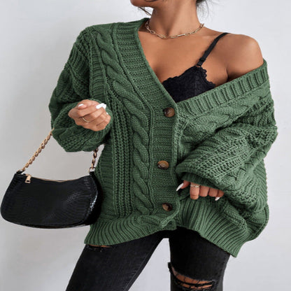 A woman wearing a wine red V-neck knitted cardigan with lantern sleeves, paired with a black top and black ripped jeans. She is also carrying a black bag and wearing black shoes.