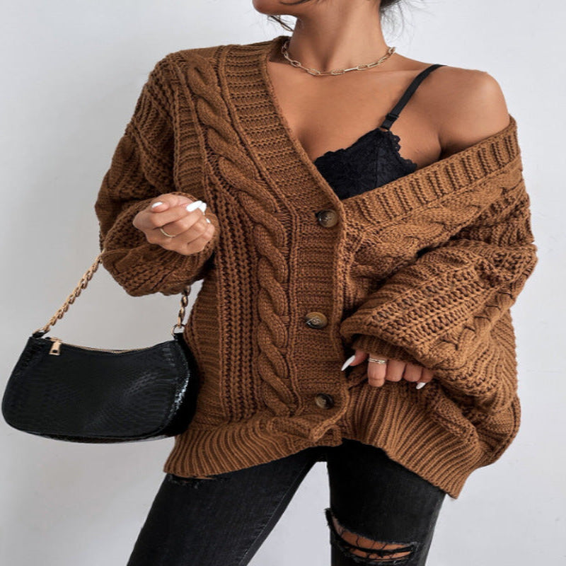 A woman wearing a wine red V-neck knitted cardigan with lantern sleeves, paired with a black top and black ripped jeans. She is also carrying a black bag and wearing black shoes.