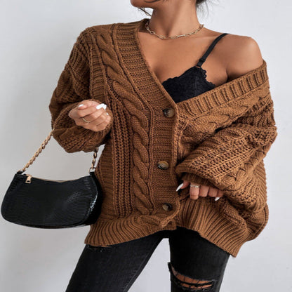 A woman wearing a wine red V-neck knitted cardigan with lantern sleeves, paired with a black top and black ripped jeans. She is also carrying a black bag and wearing black shoes.