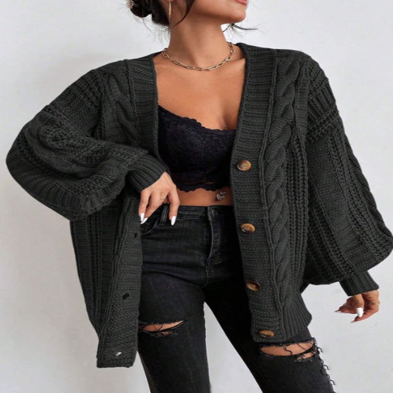 A woman wearing a wine red V-neck knitted cardigan with lantern sleeves, paired with a black top and black ripped jeans. She is also carrying a black bag and wearing black shoes.