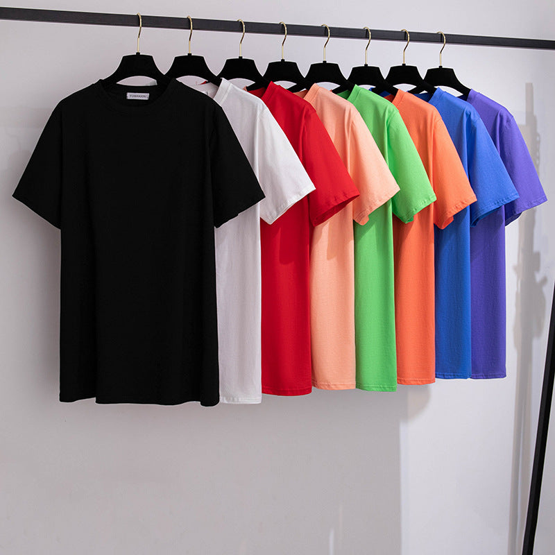 A selection of short-sleeved t-shirts in various solid colors, displayed on hangers in a row.