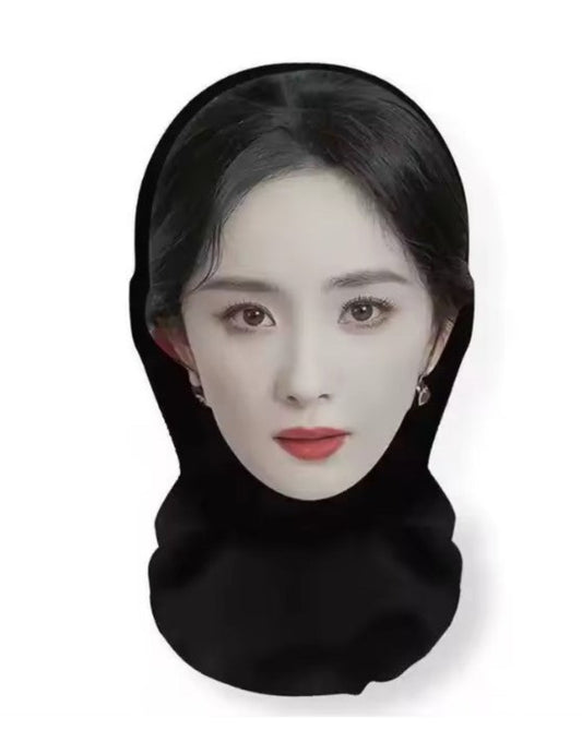 A novelty face mask shaped like a woman's face with black hair and a black neck gaiter, shown against a plain white background.