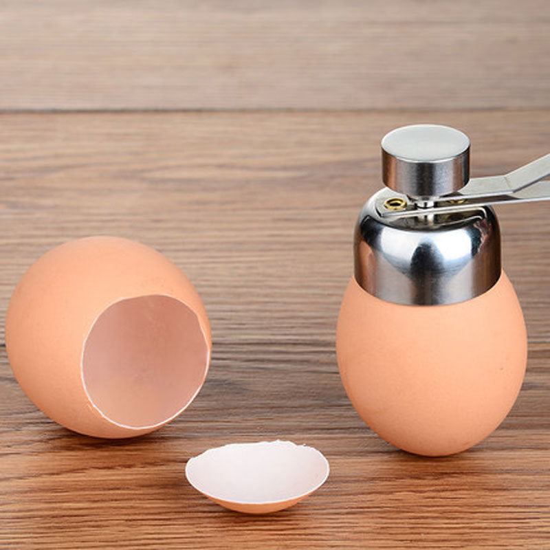 Egg shell opener with a cracked egg on a wooden surface