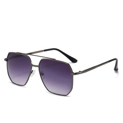 Sunglasses with dark gradient lenses and thin metal frame on a white background