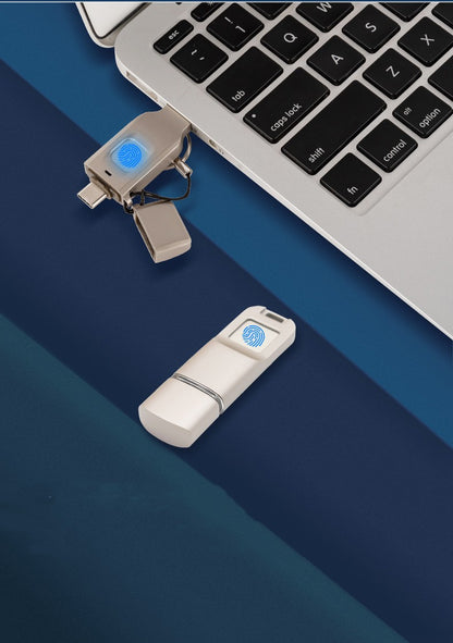 Two USB drives on a blue surface with a laptop in the background