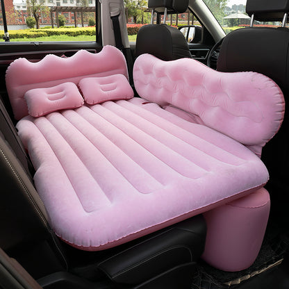 Inflatable pink car bed set inside a vehicle