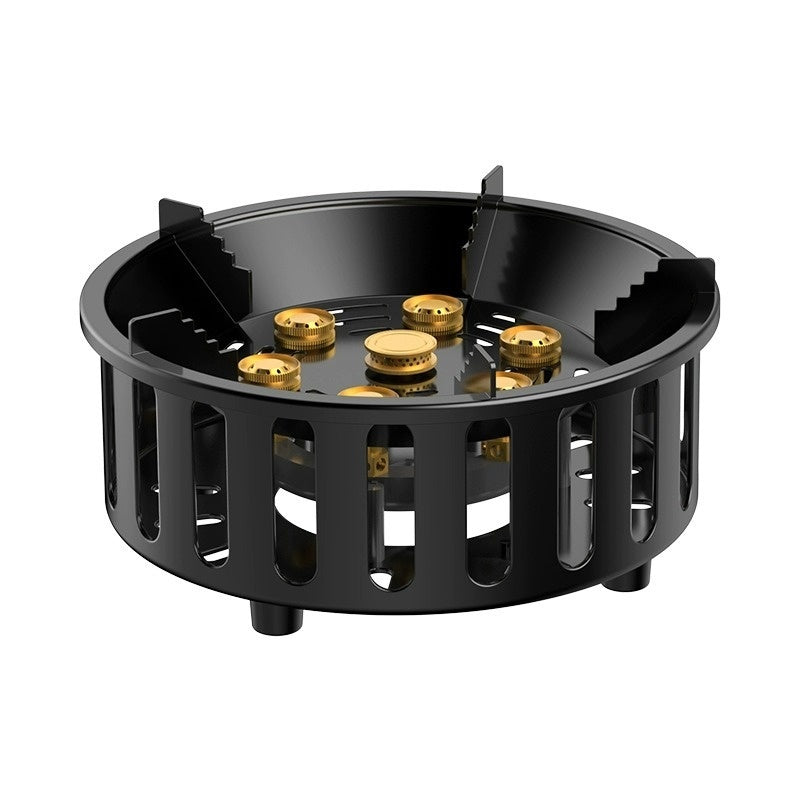 Black gas stove burner with gold coils on a white background