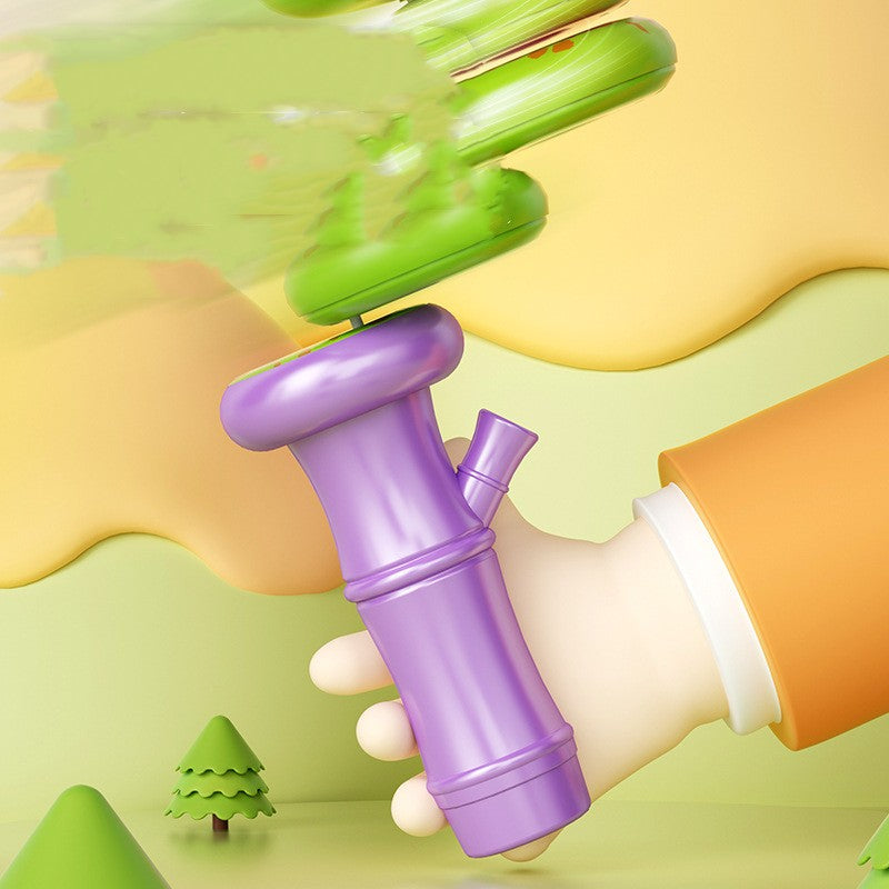 Purple toy with a green top held by a hand against a colorful background