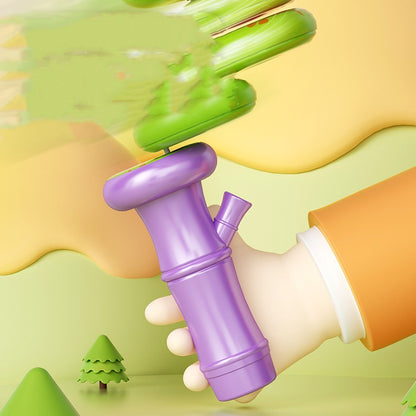 Purple toy with a green top held by a hand against a colorful background