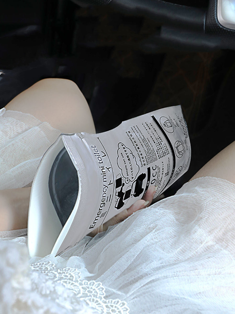 Emergency mini toilet with instructions held by a person in white pants.