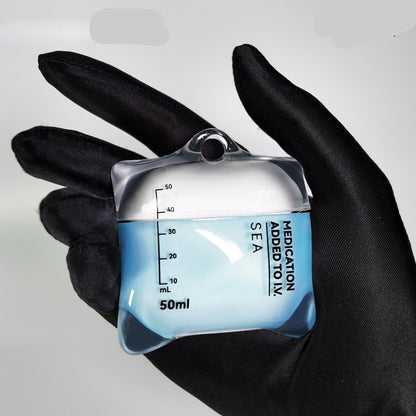 AirPods case designed like a medical container with measurement markings, held in a black glove.