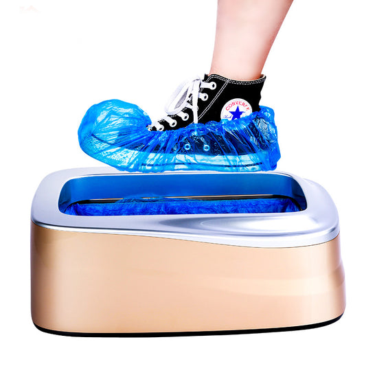 Person wearing blue shoe covers stepping into a foot bath machine with a white background