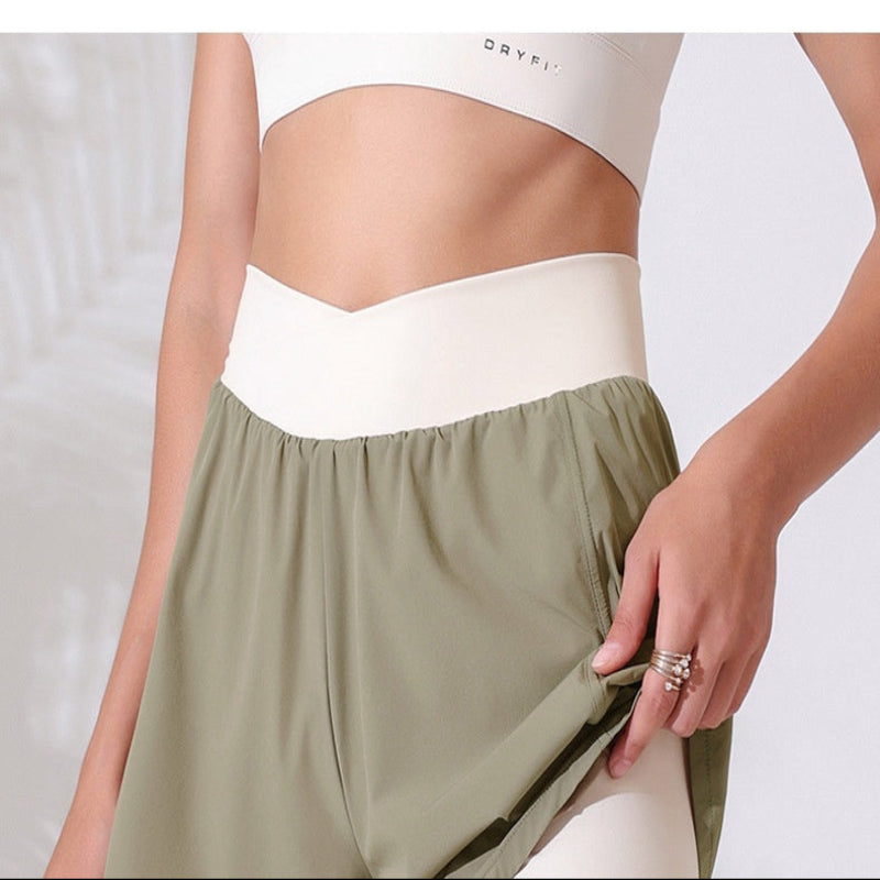 Olive green shorts worn by a person on a white background