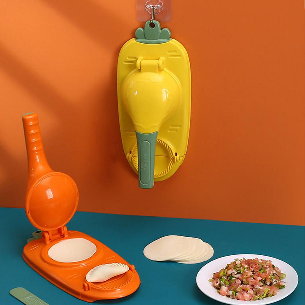 Two colorful tortilla makers on a blue surface with a plate of salad against an orange wall.