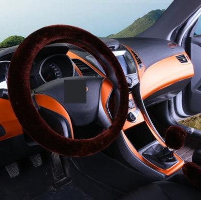 Car interior with a brown steering wheel cover and orange dashboard.